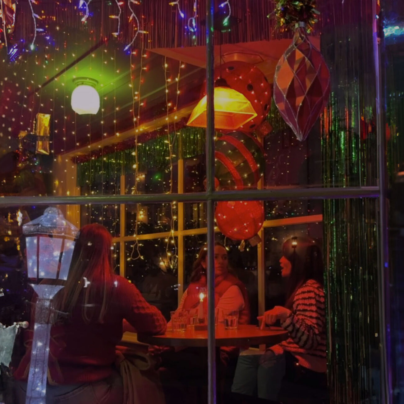 Window of tavern with holiday lights and decor